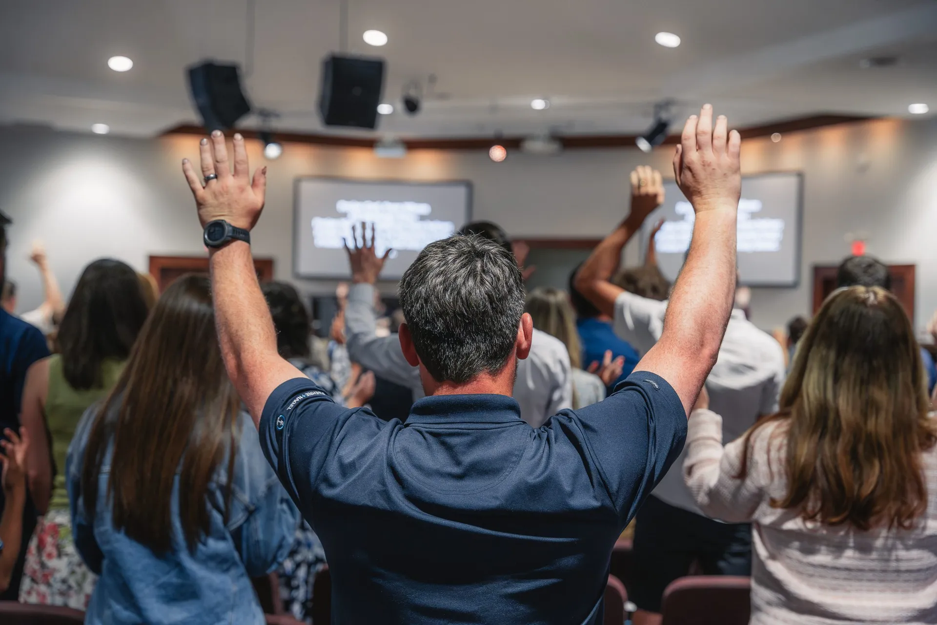 Congregation worshipping with hands raised